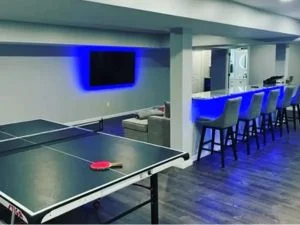 Interior recreation room with ping pong table and bar seating